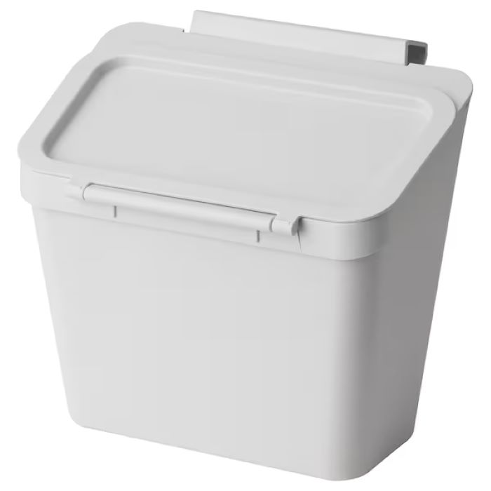 Waste bin for cabinet with door