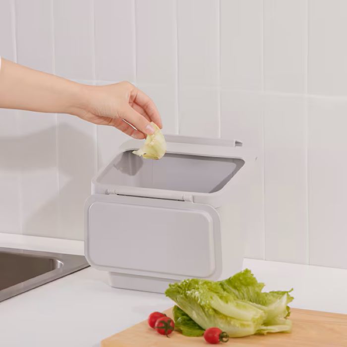 Waste bin for cabinet with door